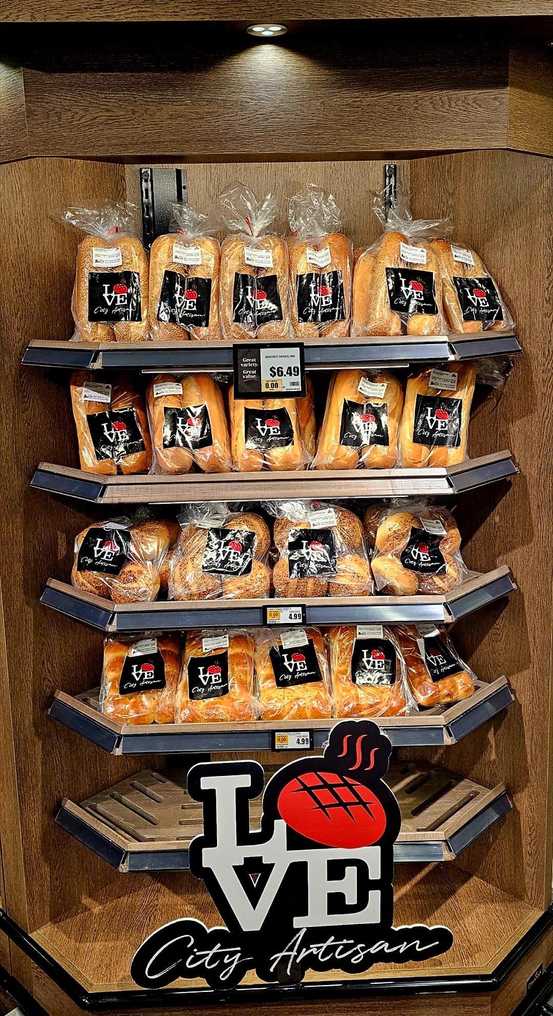 Love City Artisan breads displayed on shelves in a ShopRite bakery
